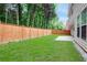Spacious backyard featuring a lush lawn, privacy fence, and room for outdoor activities at 4087 Kingsley Park Ct, Peachtree Corners, GA 30096