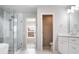 Bright bathroom with glass-enclosed shower, soaking tub, and white double sink vanity at 4087 Kingsley Park Ct, Peachtree Corners, GA 30096