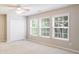 Carpeted bedroom featuring multiple windows and a closet at 4087 Kingsley Park Ct, Peachtree Corners, GA 30096