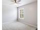Cozy bedroom featuring neutral walls, carpet flooring, and a window for natural light at 4087 Kingsley Park Ct, Peachtree Corners, GA 30096
