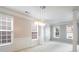 Elegant dining area featuring a modern chandelier, columned accents and abundant natural light at 4087 Kingsley Park Ct, Peachtree Corners, GA 30096