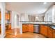 Open-concept kitchen with stainless steel appliances, ample storage, and hardwood floors throughout at 4087 Kingsley Park Ct, Peachtree Corners, GA 30096