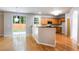 Open kitchen with stainless appliances, breakfast bar, hardwood floors and sliding glass door at 4087 Kingsley Park Ct, Peachtree Corners, GA 30096