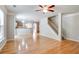 Living area with gleaming hardwood floors, open to kitchen and stairwell at 4087 Kingsley Park Ct, Peachtree Corners, GA 30096