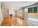 Bright living room with wood floors, fireplace, ceiling fan, and sliding glass door to the outside at 4087 Kingsley Park Ct, Peachtree Corners, GA 30096