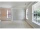 Bright living room with wainscoting, crown molding, and large windows creating a cozy atmosphere at 4087 Kingsley Park Ct, Peachtree Corners, GA 30096