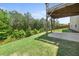 A flat concrete patio sits below a wooden deck in the back yard at 6660 Country Lake Rd, Cumming, GA 30041
