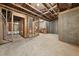 Spacious unfinished basement with exposed wooden framing and concrete foundation walls at 6660 Country Lake Rd, Cumming, GA 30041