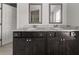 Bathroom featuring double sinks with granite countertops and dark cabinets at 6660 Country Lake Rd, Cumming, GA 30041