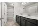 Modern bathroom with a double vanity, white countertops, and a combined shower and tub at 6660 Country Lake Rd, Cumming, GA 30041