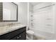 Bathroom features granite countertop, framed mirror, and shower-tub combo at 6660 Country Lake Rd, Cumming, GA 30041