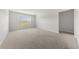 Spacious bedroom with neutral carpet, a bright window, and ample natural light at 6660 Country Lake Rd, Cumming, GA 30041