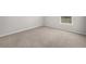 This bedroom features neutral walls, soft carpet, and a bright window at 6660 Country Lake Rd, Cumming, GA 30041
