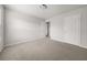 A bedroom featuring neutral walls, plush carpet, and a convenient closet at 6660 Country Lake Rd, Cumming, GA 30041