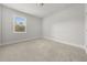 Simple bedroom with plush carpet, neutral paint, and a single window at 6660 Country Lake Rd, Cumming, GA 30041