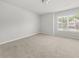 Bedroom featuring neutral walls, carpeted floors, and a bright window at 6660 Country Lake Rd, Cumming, GA 30041