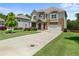 Charming two-story home featuring stone accents, a two-car garage, and a well-manicured front lawn at 6660 Country Lake Rd, Cumming, GA 30041