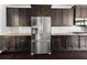 Updated kitchen boasting stainless steel refrigerator, gas range, and plentiful cabinet storage at 6660 Country Lake Rd, Cumming, GA 30041