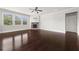 Bright living room features a stone fireplace, large windows, and gleaming hardwood floors at 6660 Country Lake Rd, Cumming, GA 30041
