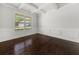 Bright, airy living room with hardwood floors, coffered ceiling, and wainscoting at 6660 Country Lake Rd, Cumming, GA 30041