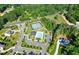 Aerial view of community featuring pool, tennis courts, and surrounding residences amidst lush greenery at 13037 Overlook Pass, Roswell, GA 30075