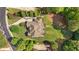Aerial view of a home with a large yard, mature trees, and a circular driveway at 13037 Overlook Pass, Roswell, GA 30075