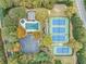 Aerial view of community amenities, including a pool, tennis courts, and ample parking surrounded by lush trees at 13037 Overlook Pass, Roswell, GA 30075