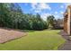 Expansive backyard with lush green grass, mature trees, and well-maintained landscaping at 13037 Overlook Pass, Roswell, GA 30075