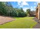 Lush green backyard with mature trees and well-maintained lawn at 13037 Overlook Pass, Roswell, GA 30075