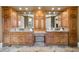 Bathroom featuring double vanity with wood cabinets and granite countertops at 13037 Overlook Pass, Roswell, GA 30075
