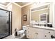 Bathroom featuring tile shower, granite countertop vanity, and neutral color scheme at 13037 Overlook Pass, Roswell, GA 30075