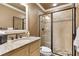 Bathroom featuring granite counters, framed mirror, and a glass enclosed shower at 13037 Overlook Pass, Roswell, GA 30075