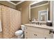 Cozy bathroom with granite counter, white vanity and shower with curtain at 13037 Overlook Pass, Roswell, GA 30075