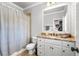 Cozy bathroom with granite countertop, vanity, updated fixtures, and shower with curtain at 13037 Overlook Pass, Roswell, GA 30075