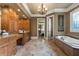 Bathroom with soaking tub, granite counters, and decorative window at 13037 Overlook Pass, Roswell, GA 30075