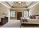 Large main bedroom with a trey ceiling, shuttered windows, and ample space for furniture at 13037 Overlook Pass, Roswell, GA 30075