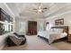 Spacious bedroom featuring a trey ceiling, ceiling fan, and a large window with natural light at 13037 Overlook Pass, Roswell, GA 30075