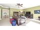 Large bonus room featuring a comfortable seating area, media center, and view of the upstairs railing at 13037 Overlook Pass, Roswell, GA 30075