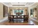 This dining room features a rustic table, bench seating, and stylish chandelier at 13037 Overlook Pass, Roswell, GA 30075