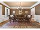 Formal dining room with hardwood floors, chandelier, and elegant wainscoting at 13037 Overlook Pass, Roswell, GA 30075