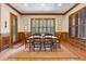 Dining room with natural light, hardwood floors, wooden window shutters, and wainscotting at 13037 Overlook Pass, Roswell, GA 30075