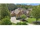 Stately brick home with lush landscaping, circular drive, and mature trees at 13037 Overlook Pass, Roswell, GA 30075