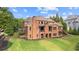 Exterior of a large brick home with a wooden deck and a stone fireplace on an enclosed porch at 13037 Overlook Pass, Roswell, GA 30075