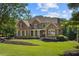 Beautiful brick home featuring a well-manicured lawn and charming architectural details at 13037 Overlook Pass, Roswell, GA 30075