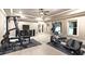 Home gym with an elliptical machine, weightlifting machine, and mounted television at 13037 Overlook Pass, Roswell, GA 30075