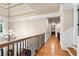 Elegant hallway with hardwood floors, detailed molding, and a view of the foyer's chandelier at 13037 Overlook Pass, Roswell, GA 30075