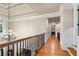 Upstairs hallway with hardwood floors, decorative railing, crown molding, and access to multiple rooms at 13037 Overlook Pass, Roswell, GA 30075