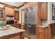 Gourmet kitchen with stainless steel refrigerator and custom wood cabinets at 13037 Overlook Pass, Roswell, GA 30075