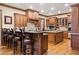 Large open kitchen with wooden cabinets and bar stool seating at 13037 Overlook Pass, Roswell, GA 30075