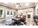 Cozy living room with a cowhide rug, and a leather sofa set facing the double doors at 13037 Overlook Pass, Roswell, GA 30075